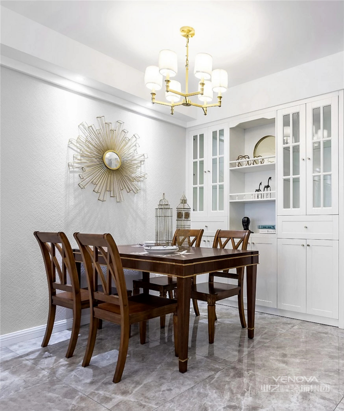餐厅选用深色木质餐桌椅，让空间多了一份沉稳的感觉。金色吊灯与立体感十足的墙饰，提升空间质感与精致度。
