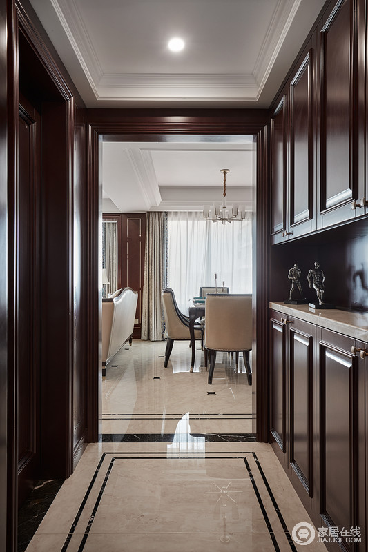 入门玄关处，深棕褐色玄关柜结合门套配色，极具古典主义，将实用性凸显出来，整体上的典雅、稳重，让空间变得格外安静。