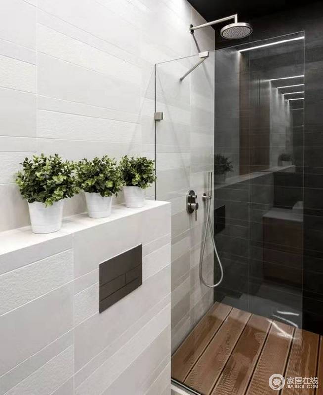 卫生间以黑白为主，玻璃淋浴门解决了功能设计，白色石墙的盆栽点缀出生机，不显枯燥。