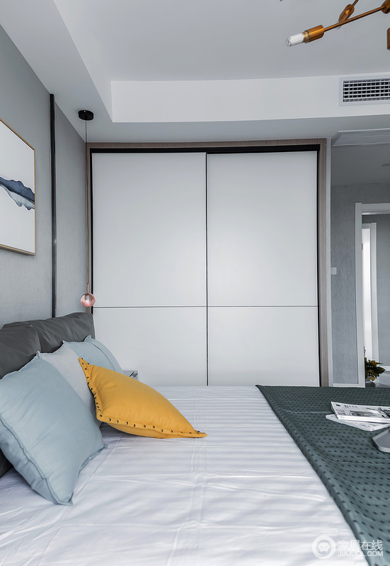 卧室空间采用灰色作为主色调，干净纯粹的质感宛如出淤泥而不染的气质；简单纯净的设计搭配简约的白色衣柜、墨云悠然的画作，以清和平静地方式，让卧室更为舒适。