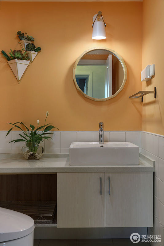 卫生间大胆的使用热烈的橙黄色，温暖的色系赋予空间新的生命力；墙裙和盥洗区则保持色彩的一致，使空间看上去毫无违和，反而更加展现出时髦的品味。