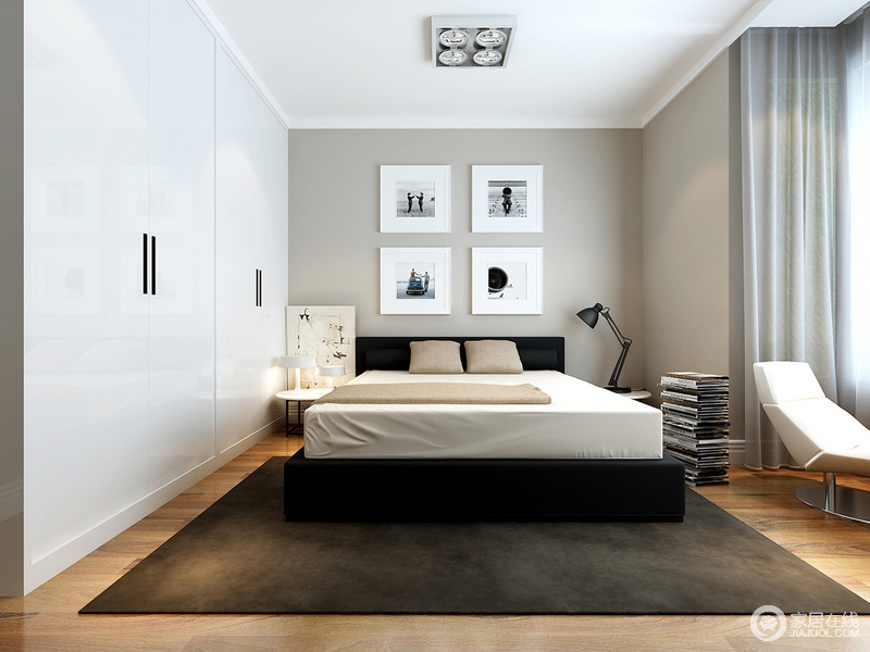 卧室中设计师以精简的方式和素雅的用色来构建温馨、宁静，让人在疲劳之后，能够修身养性；白色衣柜与黑白简画让灰淡的立面有了艺术感，黑色地毯和工业风浓重的家具，扫去沉闷，尤为简洁生动。
