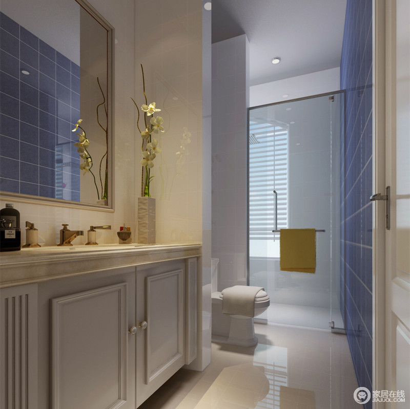 卫浴空间呈狭长型，盥洗台、马桶及淋浴功能区规整靠边排列，通过隔断墙划分；海蓝色方砖铺贴，在白色空间中愈加显得清新舒爽，折射在浴室镜里，增强空间互动性。