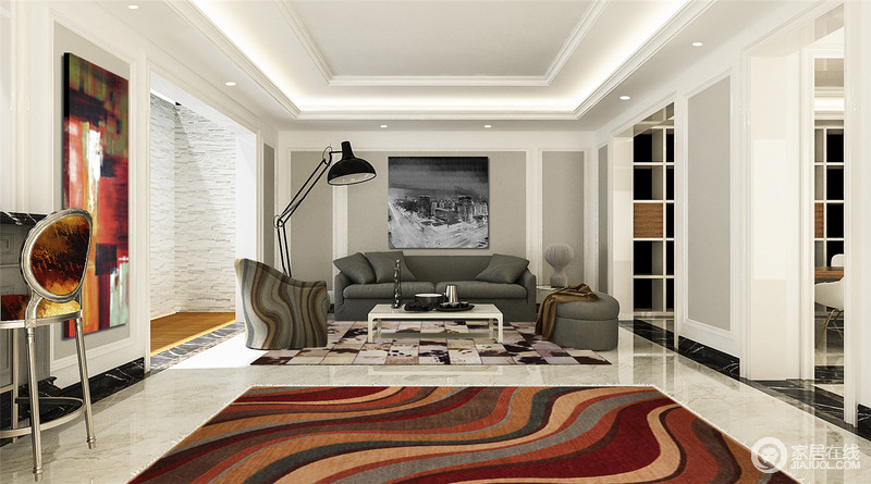 灰色立面化解了白色的单调，黑白摄影画和彩色抽象油画以不同的意蕴、色彩让空间凝结着不同艺术带来的风趣；灰色系沙发旁的曲线单人沙发和粉色调的地毯裹挟着雅致与彩色曲线地毯愈添明快。