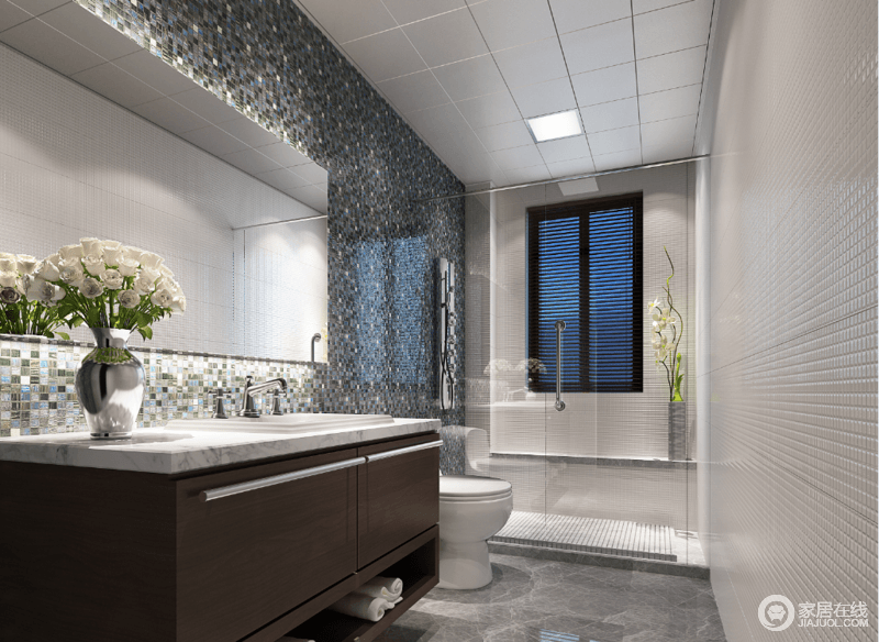 卫浴间白色方砖与绿色马赛克墙面相对，对比中突显出自然清新；褐色盥洗台在灰白大理石台面的点缀中更显灵动，简单的分区设计，减少了生活的局限，令空间愈加灵活舒适。
