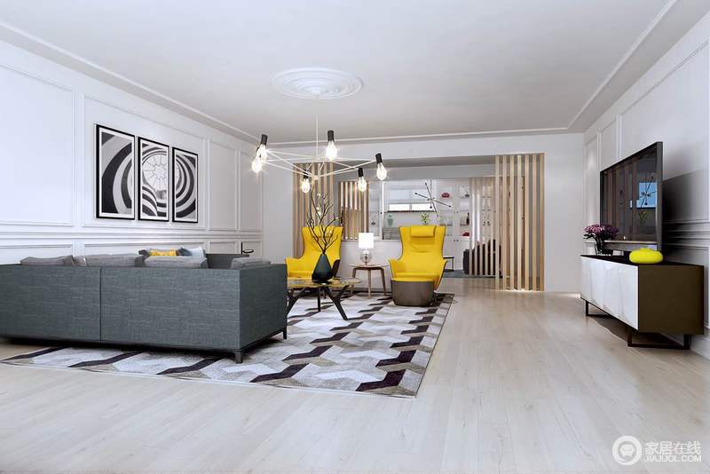 客厅以白色为基底，护墙板制造立体装饰感。墙饰挂画与拼色地毯上的几何图案形成呼应。灰色系的沙发同柠檬黄沙发椅，使相对空旷清冷的客厅有了温度和活泼感。