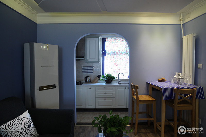 拱形门让厨房与餐厅简单分区，淡紫色的立面令空间更显独特。