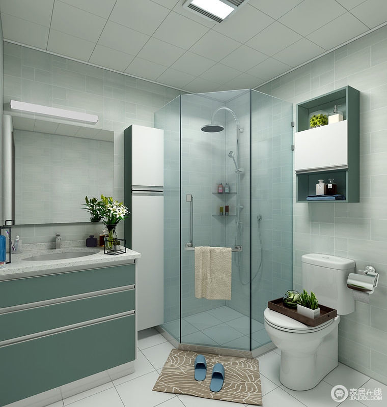 卫生间以豆绿色瓷砖铺贴墙面，而角落被做成了淋浴区，不仅巧妙增加了功能，而且化解了干湿的问题，防滑垫的配置，更显贴心。