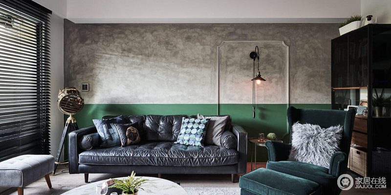 客厅保留原始的墙面，刷一米高的绿色乳胶漆，绿色跟灰色的碰撞，擦出生机活泼；挂式壁灯的工业设计，与圆几异曲同工之妙，呼应着皮质沙发，让家格外精致。
