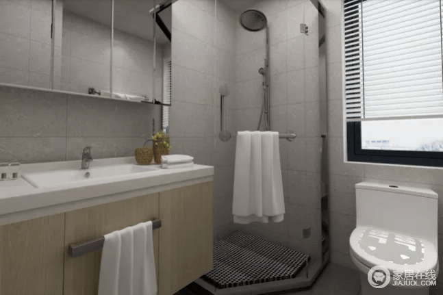 卫生间采用了浅灰色的地砖和墙砖来铺贴空间，素静之余，空间更为利落；转角做成淋浴室巧妙增强了空间，同时，借镜面玻璃柜和盥洗台以实用之能，让生活更为便捷。