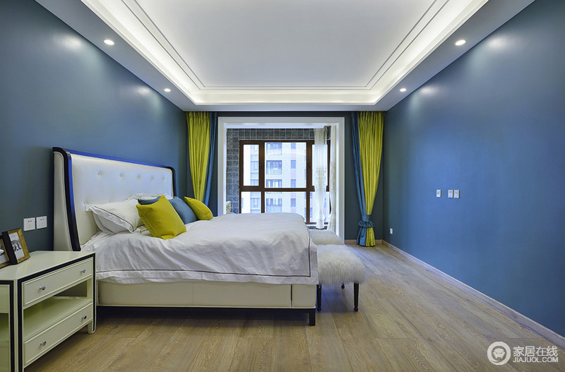 大面积的深蓝色带着悠远深邃的气质，搭配纯净的白色床品、家具，空间宛如天空般温润。极好的采光效果下，姜黄色靠包、窗帘，点缀出空间的轻盈明快。