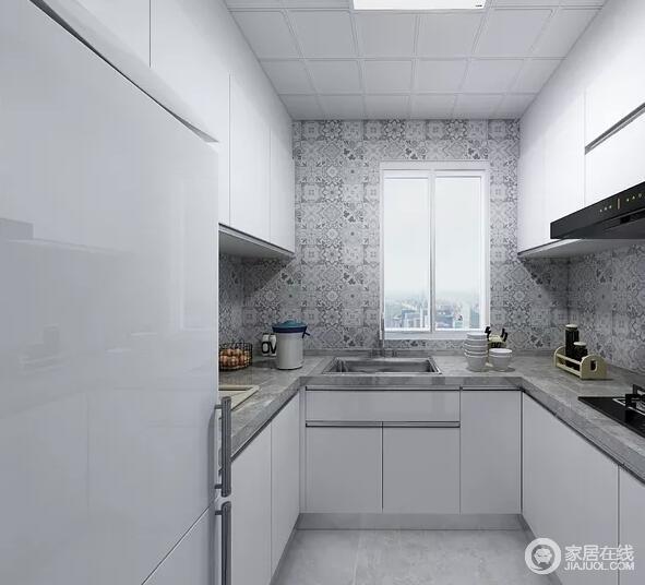 厨房以白色橱柜为主，规整而实用，灰色花砖的纹样与灰色理石台面构成一种动静，让厨房实用而美观。