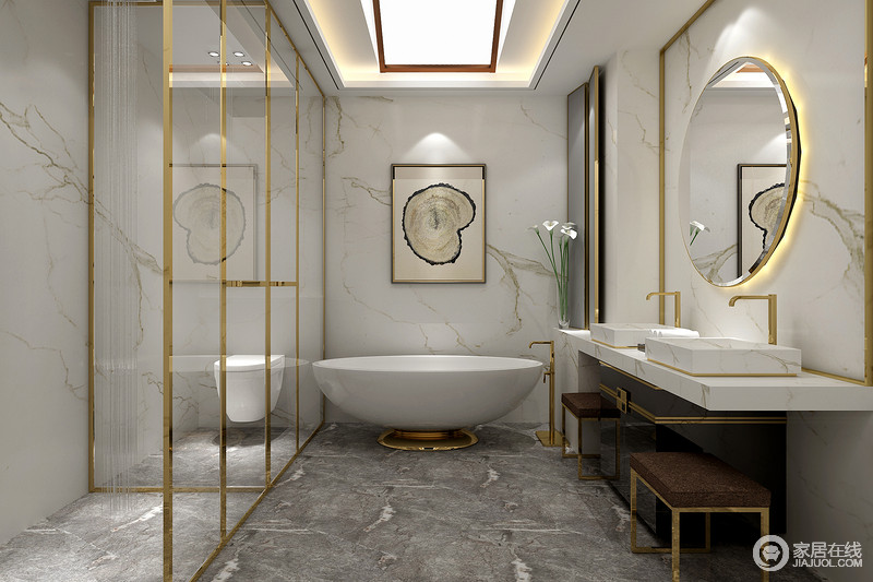白色中略带文脉的瓷砖与深灰色地面打造出冷峻简奢的卫浴空间；白色光亮的圆形浴缸、带来无尽的沐浴体验，金色的勾边装饰，令空间更显金贵。