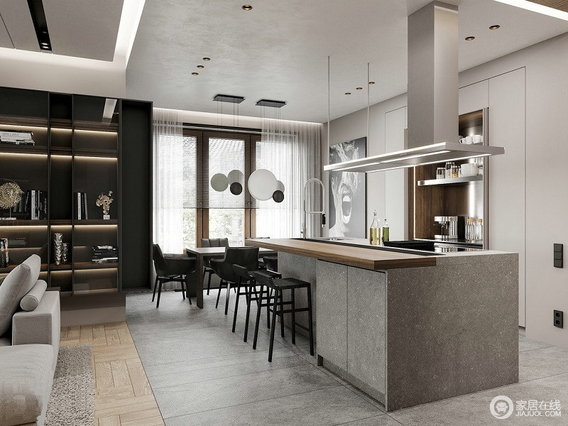 餐厅依靠厨房吧台的设计，强调空间的便利实用，让原本开放式的空间更为现代；灰色的地砖搭配灰色岛台，却因为黑色餐椅和球泡吊灯跳动着简约大气。