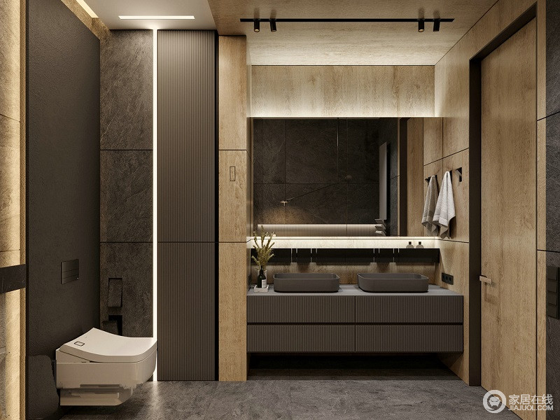 卫生间简洁明了，静谧的卫浴空间让洗浴更加舒心，深灰色盥洗台与原木打造的墙面，让空间多了自然朴质。