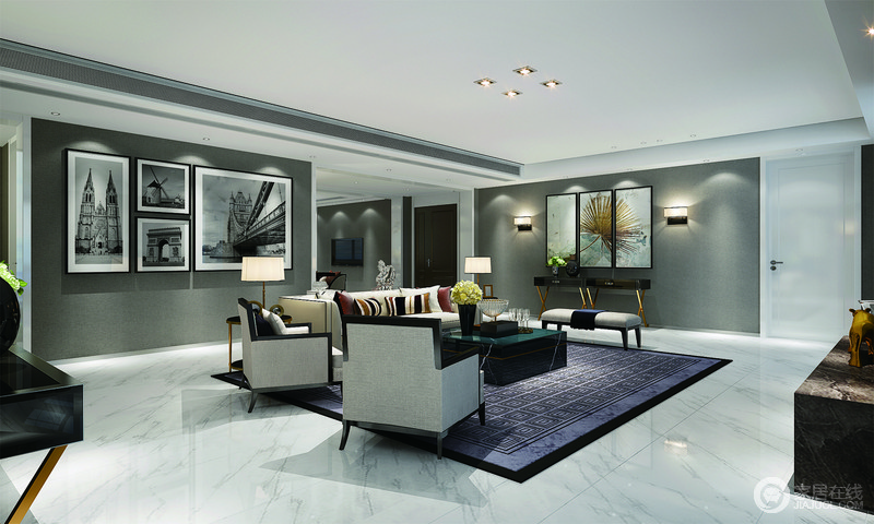 光影在空间中的作用不可忽视，客厅虽然并未设置主灯，但是点光源打在不同饱和度的灰色空间里，整体散发出强烈的时尚质感。蓝色的地毯与沙发上的靠包，则使空间多了些鲜明层次。