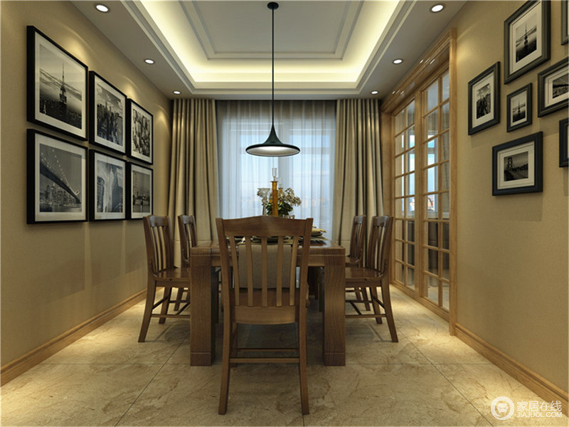 餐厅米黄色墙面与棕褐色餐桌椅色调相近，气质温和的暖色系营造出安宁的用餐环境。黑白挂画成组装饰在墙上，空间在冷暖色调间，带来平和、稳健。