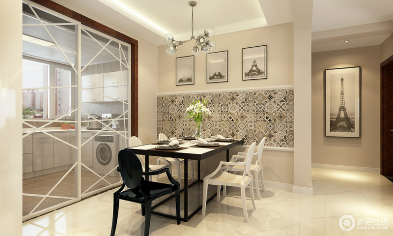 餐厅墙用花砖来搭配，令苍白空阔的墙体肌理丰富；三幅大小相同的挂画对应着黑白餐桌餐椅，装饰出空间无限时尚风潮。