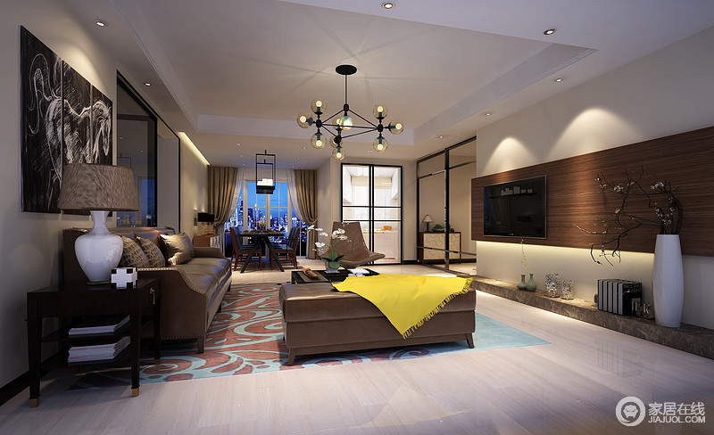 客厅以大面积的浓墨色彩的渲染，材质上的拼合，使空间彰显出雅和新贵主义。动线的纵深使空间极具视野和疏朗开阔，点缀的黄色布艺和花纹横陈的浅蓝地毯增添明艳色调。