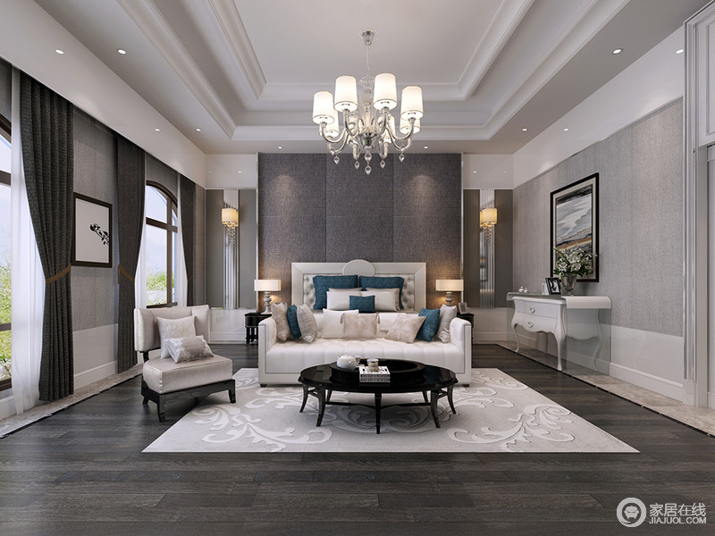 利用深灰、浅灰划分出层次明晰的空间，白色沙发和黑色圆形边几形成一个巧妙的休憩区，让卧室可发挥的作用更加多元化。