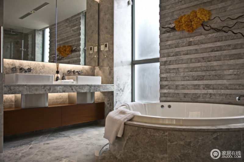 设计并没有掩盖墙体的纹路，反而将其放大，将白色盥洗台和浴缸安置在空间中，原始中夹杂着现代。